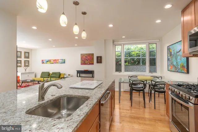 a kitchen with a stove a sink and a refrigerator