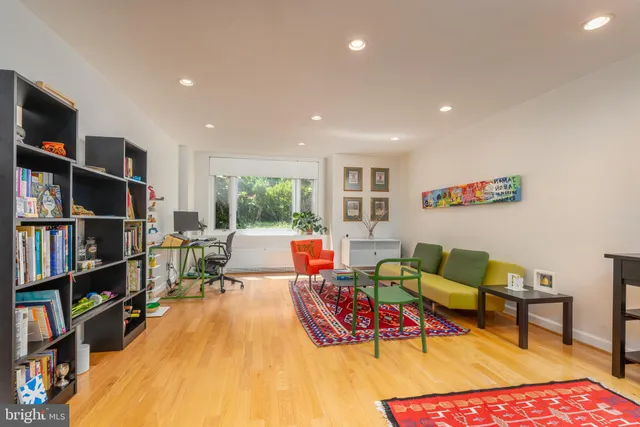 a living room with furniture and a book shelf