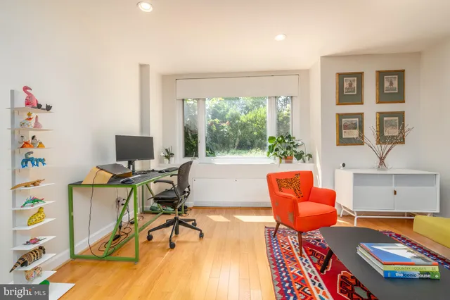 a workspace with furniture and a wooden floor