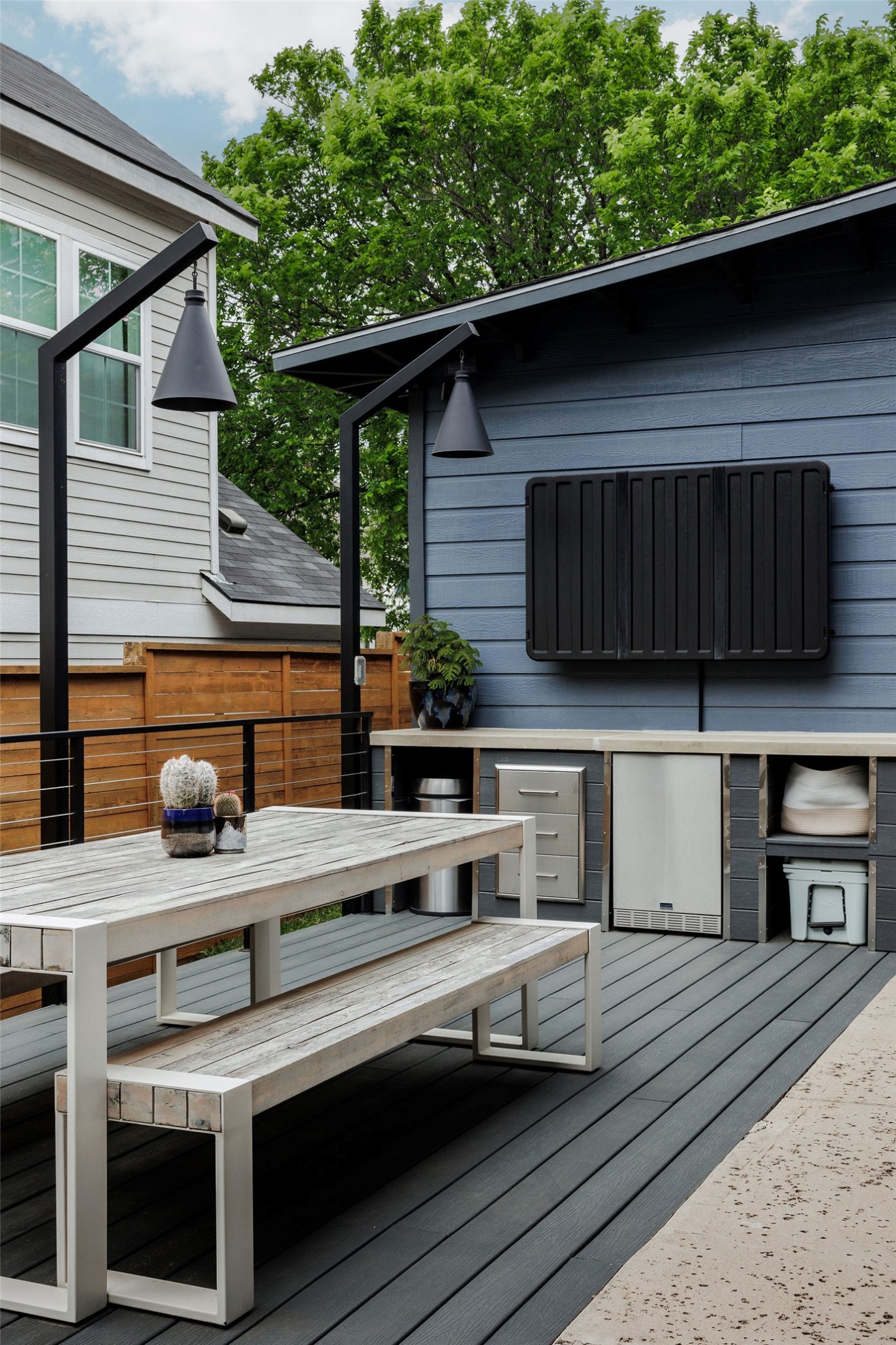 1605 Maple Avenue Austin, TX 78702 - Photo 27 of 33 Outdoor entertainment area featuring a dark composite deck, outdoor storage, and a horizontal slat privacy fence