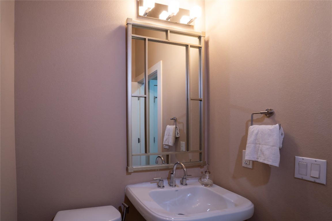8110 Ranch Road 2222, Unit 45 Austin, TX 78730 - Photo 11 of 38 a bathroom with a sink a toilet and mirror