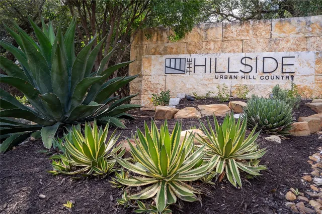 a view of a street with a sign on a wall