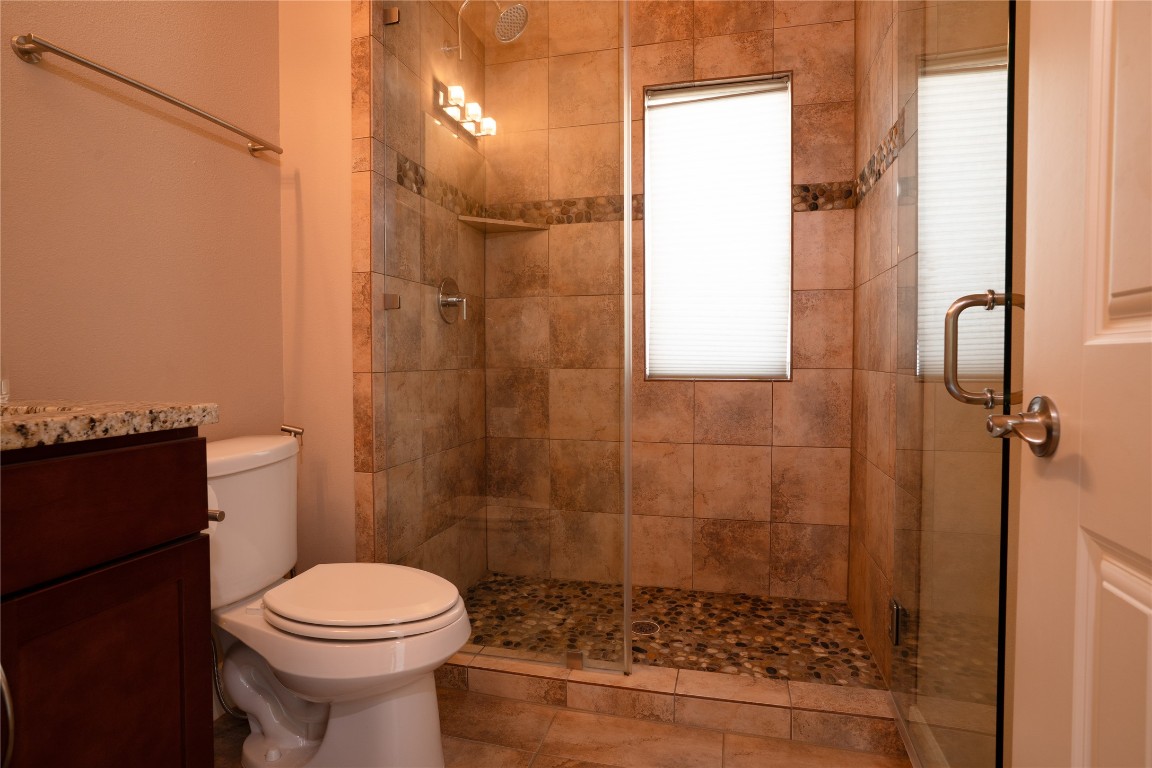 8110 Ranch Road 2222, Unit 45 Austin, TX 78730 - Photo 20 of 38 a bathroom with a toilet and a shower
