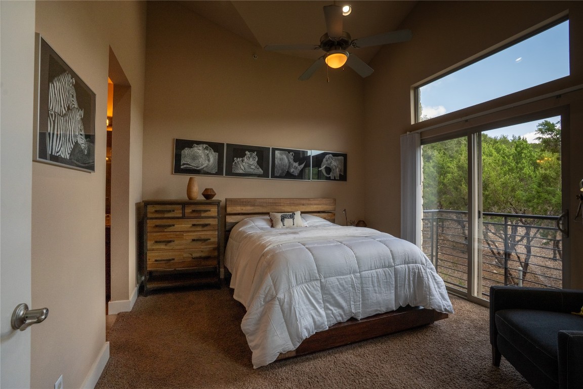 8110 Ranch Road 2222, Unit 45 Austin, TX 78730 - Photo 24 of 38 a bedroom with a bed and large window