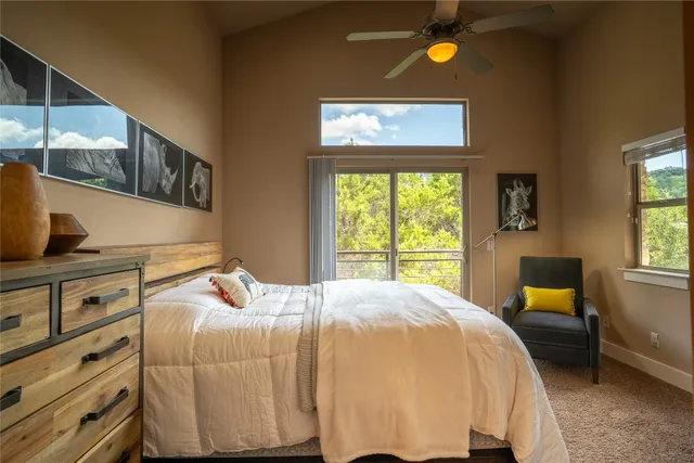 a bedroom with a bed and large window