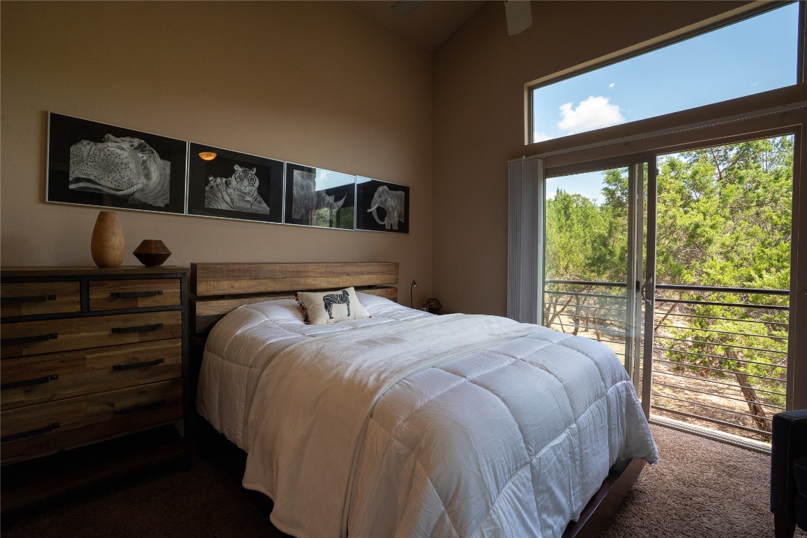 8110 Ranch Road 2222, Unit 45 Austin, TX 78730 - Photo 26 of 38 a bedroom with a bed and window