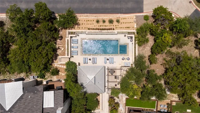 an aerial view of residential houses with outdoor space and trees