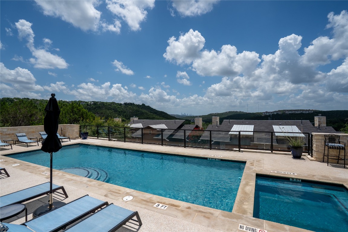 8110 Ranch Road 2222, Unit 45 Austin, TX 78730 - Photo 36 of 38 a view of a swimming pool with a table and chairs