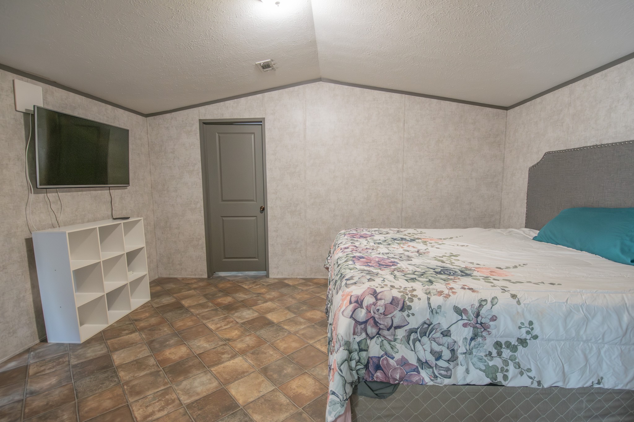 2801 County Road 444 Angleton, TX 77515 - Photo 13 of 37 a bedroom with a bed and a flat screen tv