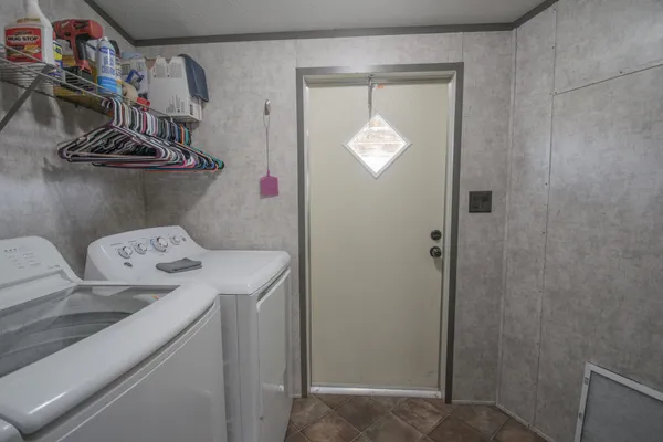 a view of a hallway with closet and wooden floor