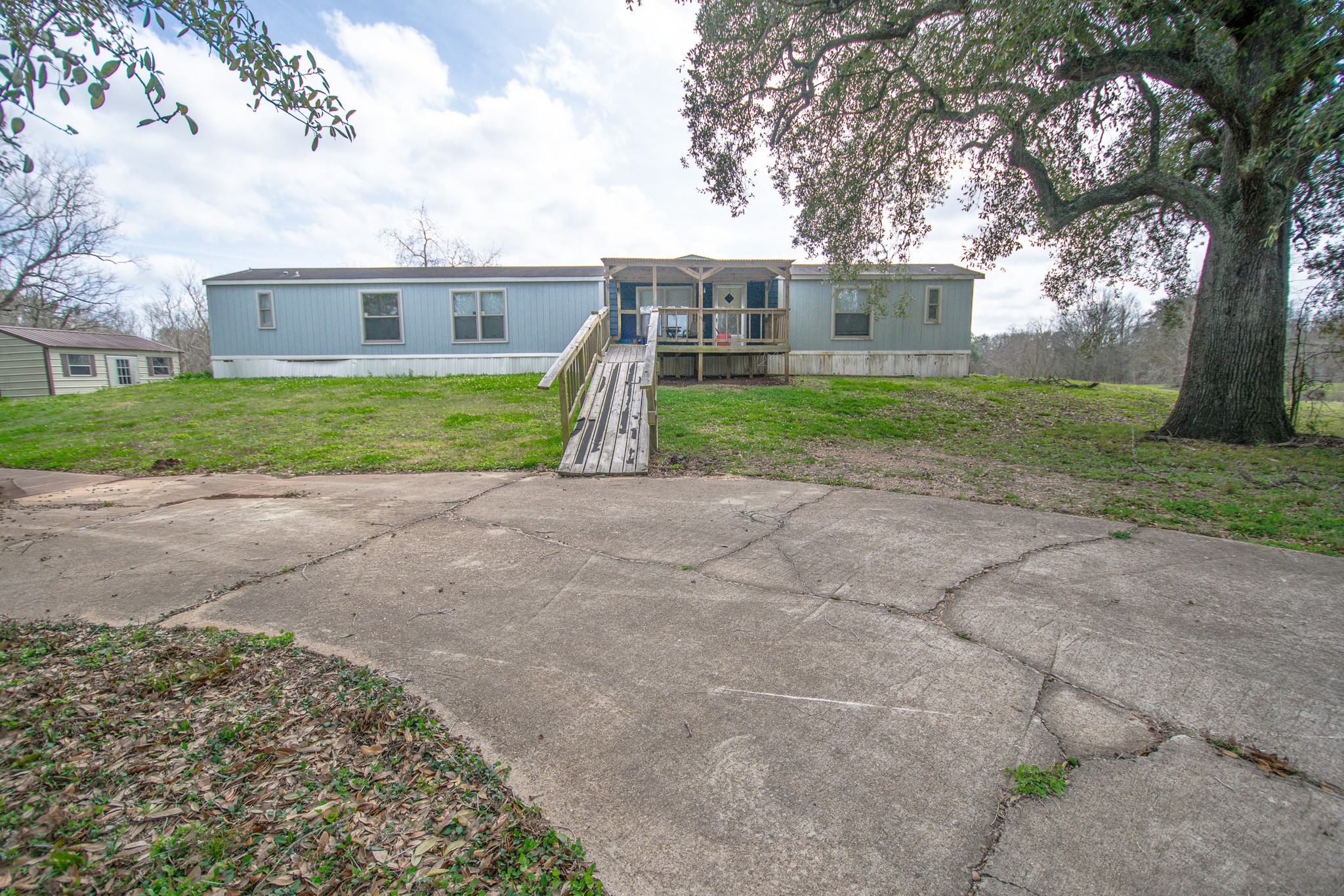 2801 County Road 444 Angleton, TX 77515 - Photo 3 of 38 front view of house with a yard and potted plants