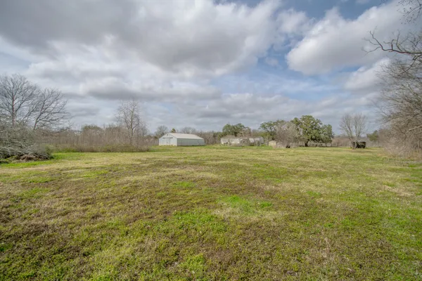 a view of a field with an ocean