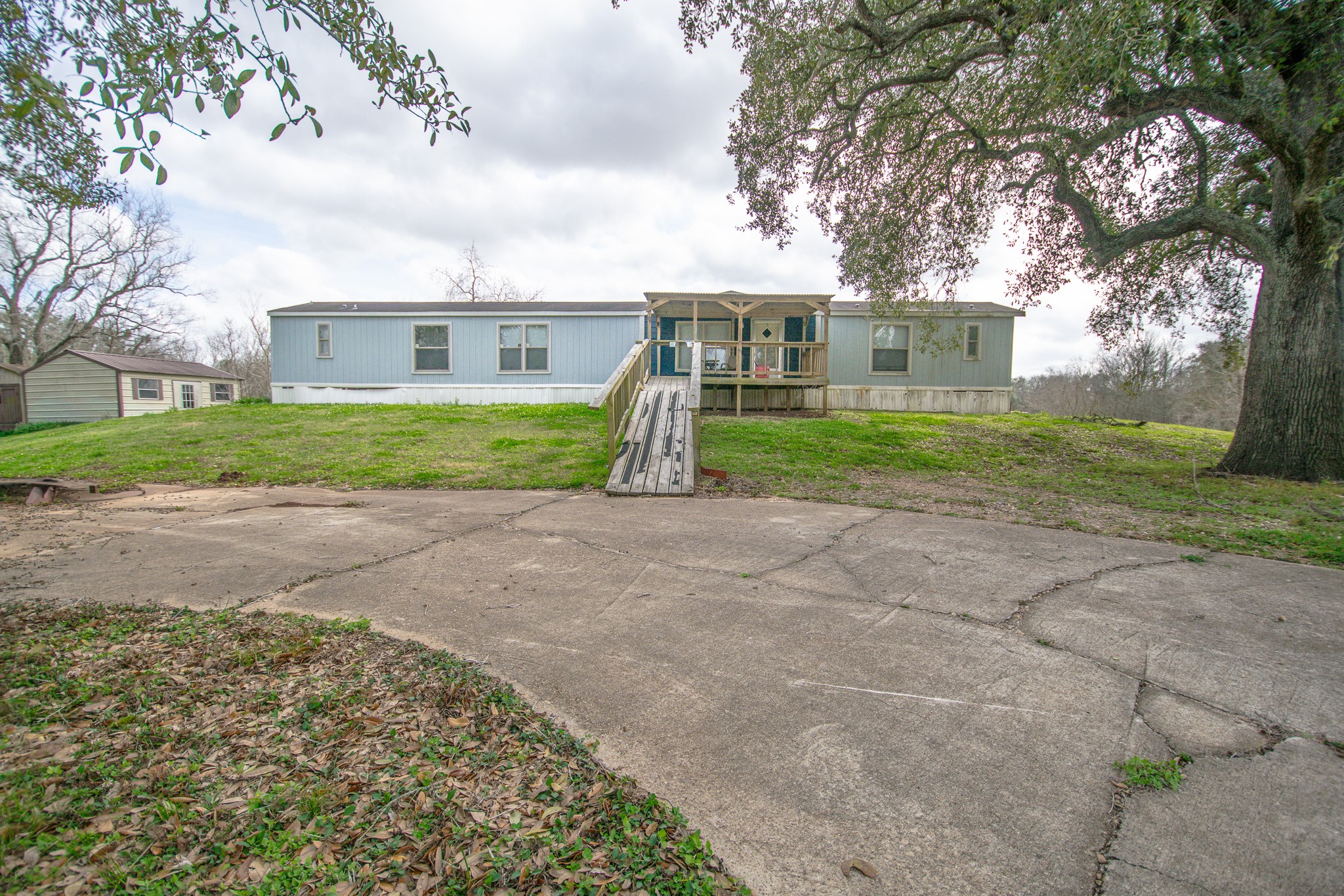 2801 County Road 444 Angleton, TX 77515 - Photo 35 of 37 a view of a big house with a big yard plants and large trees