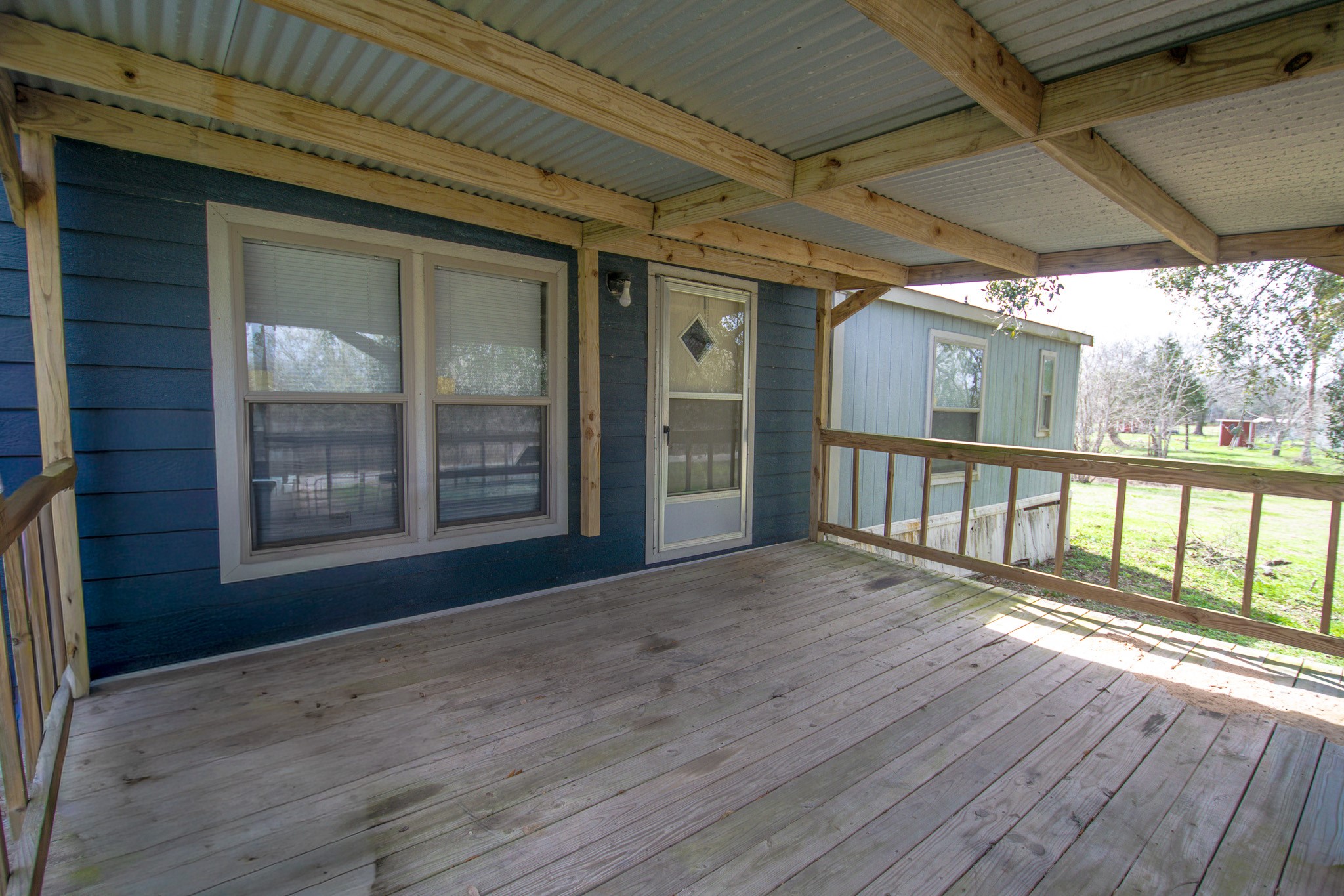 2801 County Road 444 Angleton, TX 77515 - Photo 4 of 37 an empty room with wooden floor and windows