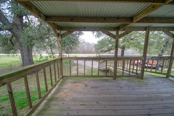 a porch with a table and chairs