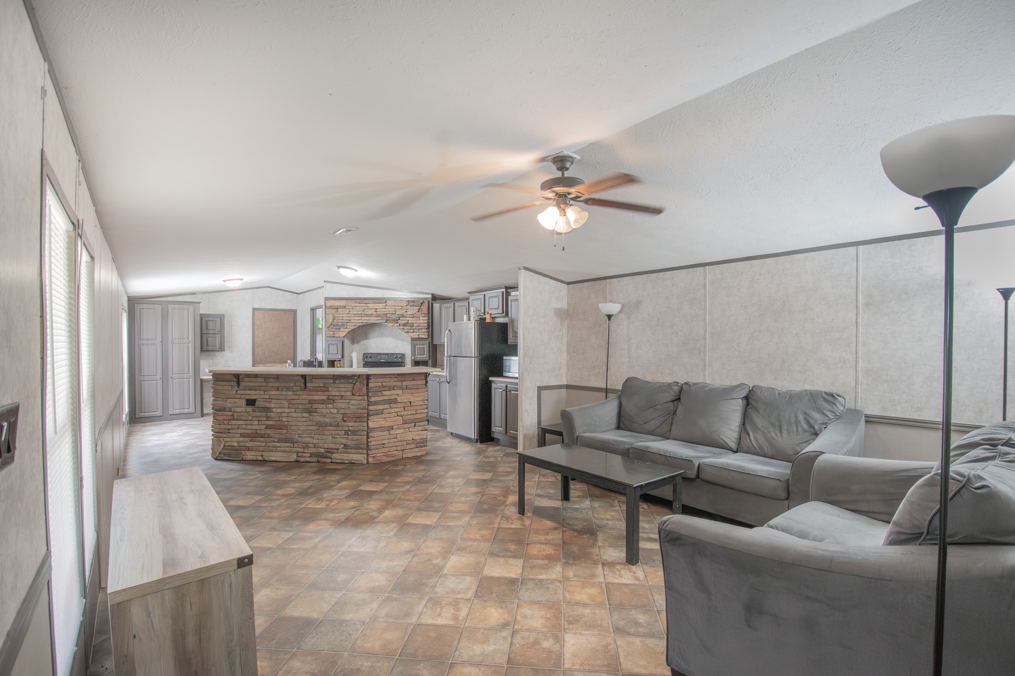 2801 County Road 444 Angleton, TX 77515 - Photo 9 of 38 a living room with furniture and a chandelier