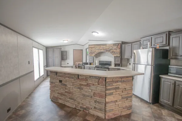 a kitchen with a sink a stove and cabinets