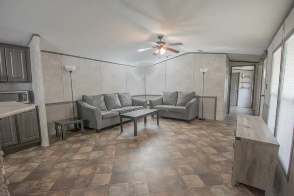 a view of kitchen with stainless steel appliances granite countertop cabinets and wooden floor