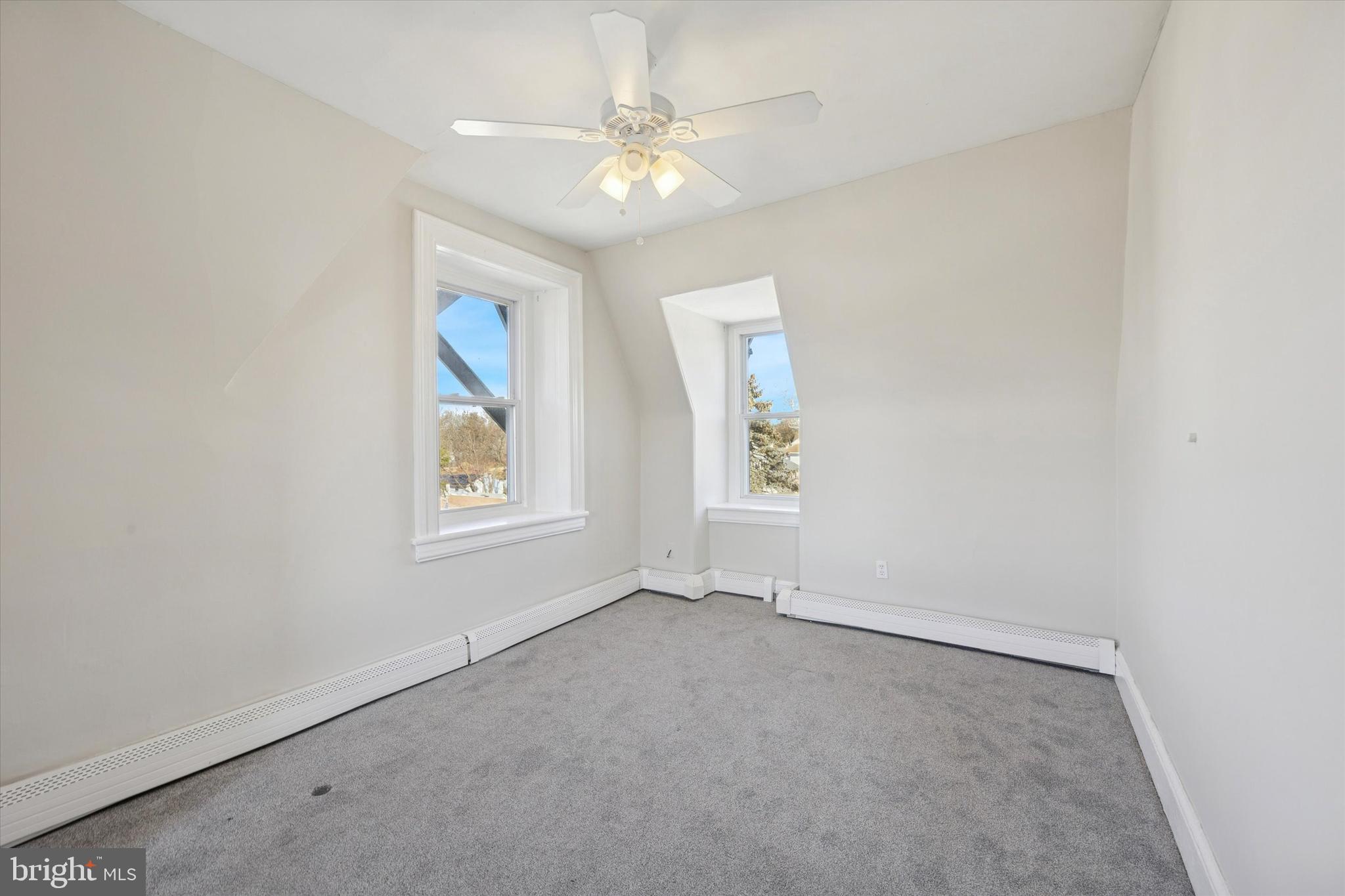 222 Henderson Avenue, Unit 3 Ridley Park, PA 19078 - Photo 13 of 15 an empty room with windows and fan