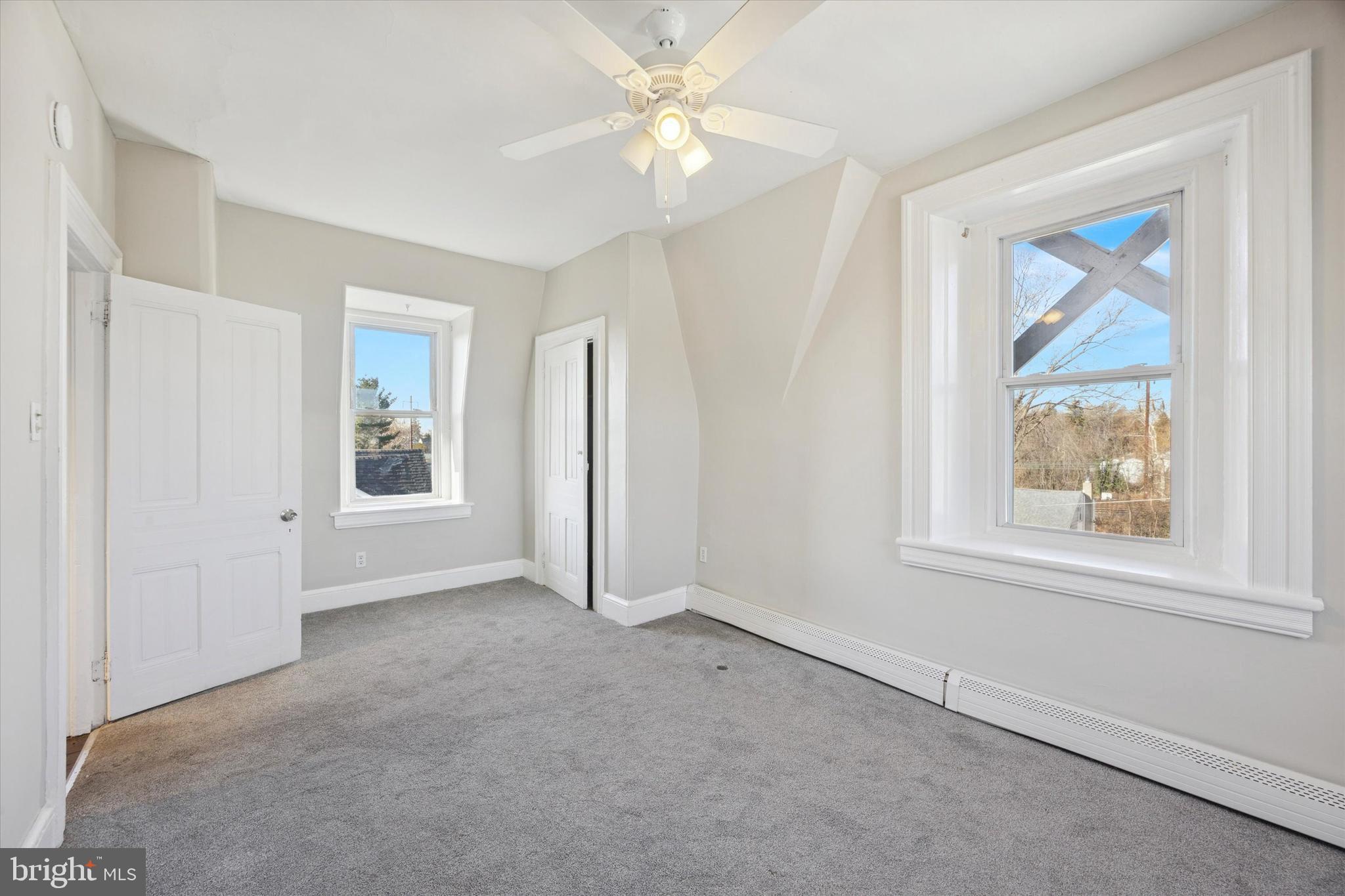 222 Henderson Avenue, Unit 3 Ridley Park, PA 19078 - Photo 14 of 15 an empty room with a window and a ceiling fan