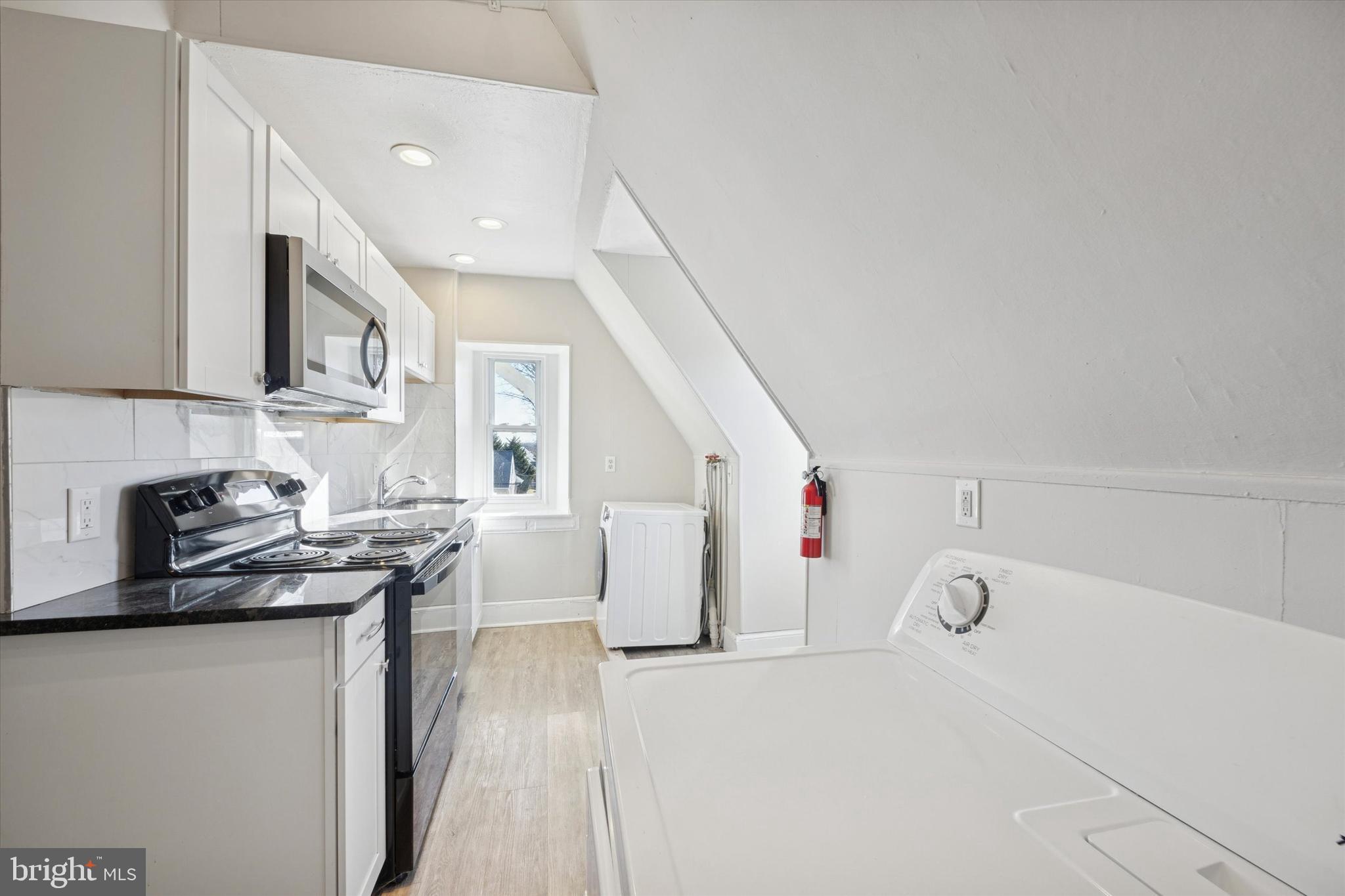 222 Henderson Avenue, Unit 3 Ridley Park, PA 19078 - Photo 5 of 15 a view of kitchen with cabinets and wooden floor