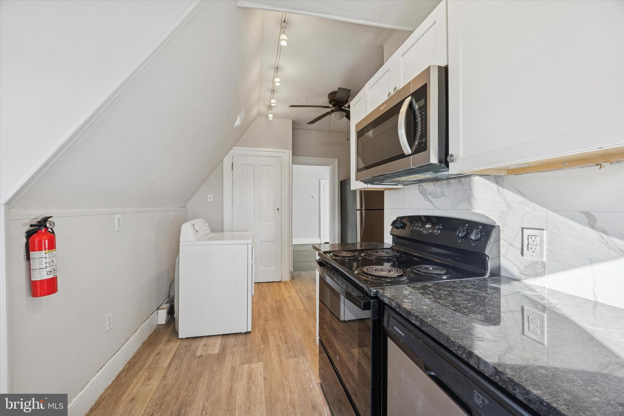 222 Henderson Avenue, Unit 3 Ridley Park, PA 19078 - Photo 7 of 15 a kitchen with stainless steel appliances granite countertop a stove and a sink