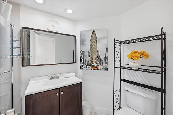 a bathroom with a sink a mirror and a shower