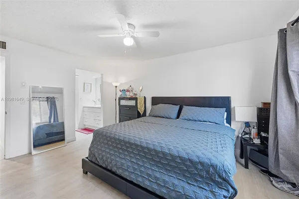 a bedroom with a bed and a mirror