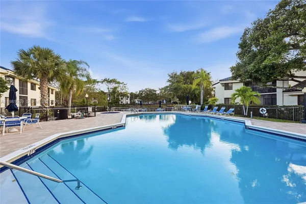 a view of swimming pool with outdoor seating and deck