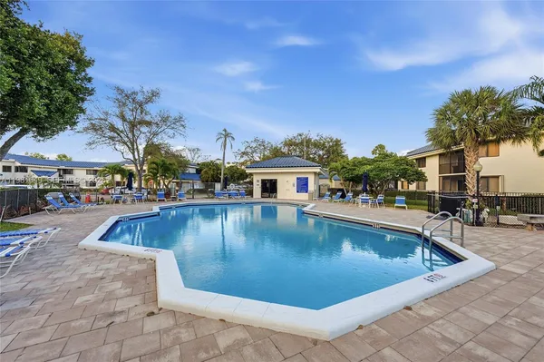 a view of a swimming pool with outdoor seating