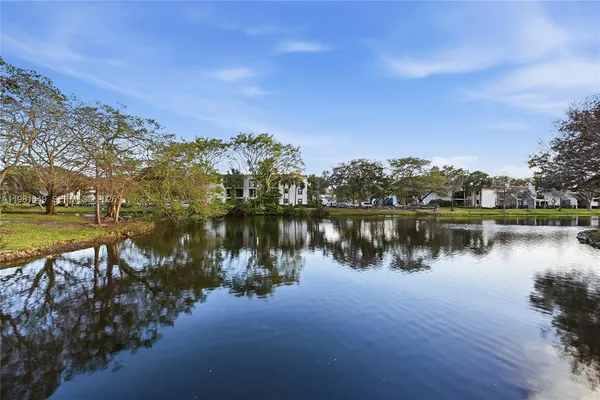 a view of a lake with houses in the back