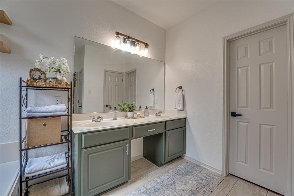 5218 Griffins Pointe Drive Rowlett, TX 75089 - Photo 18 of 40 Primary bath with freshly painted dual vanity, recent lighting and faucets.