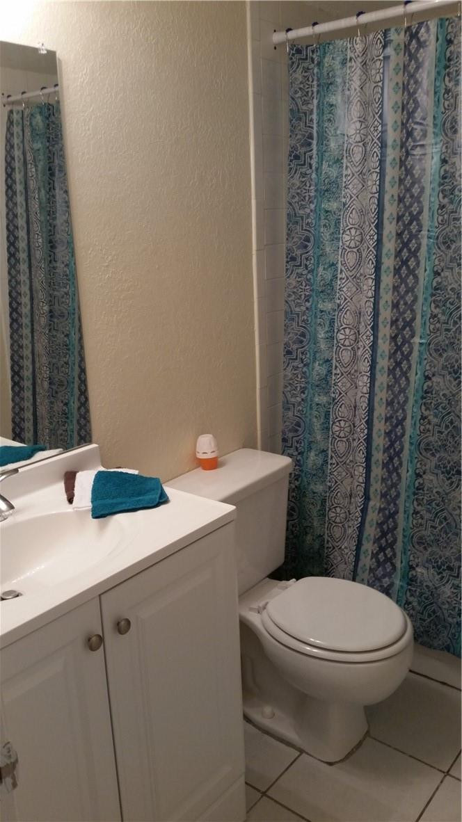 3470 Foxcroft Road, Unit 211 Miramar, FL 33025 - Photo 8 of 10 a white toilet sitting next to a bathroom sink