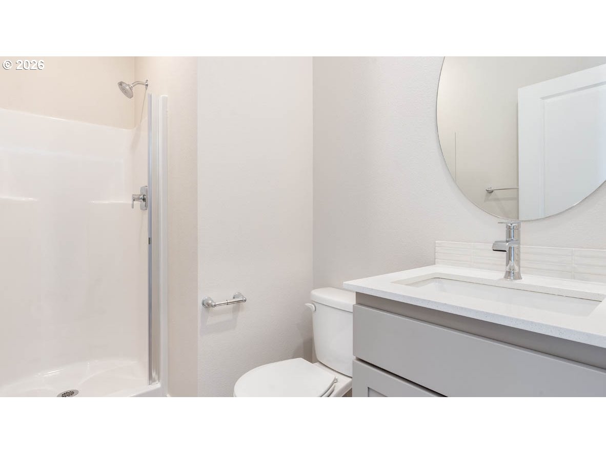 9194 Southeast Azalea Street Happy Valley, OR 97086 - Photo 11 of 32 a bathroom with a sink a toilet and a mirror