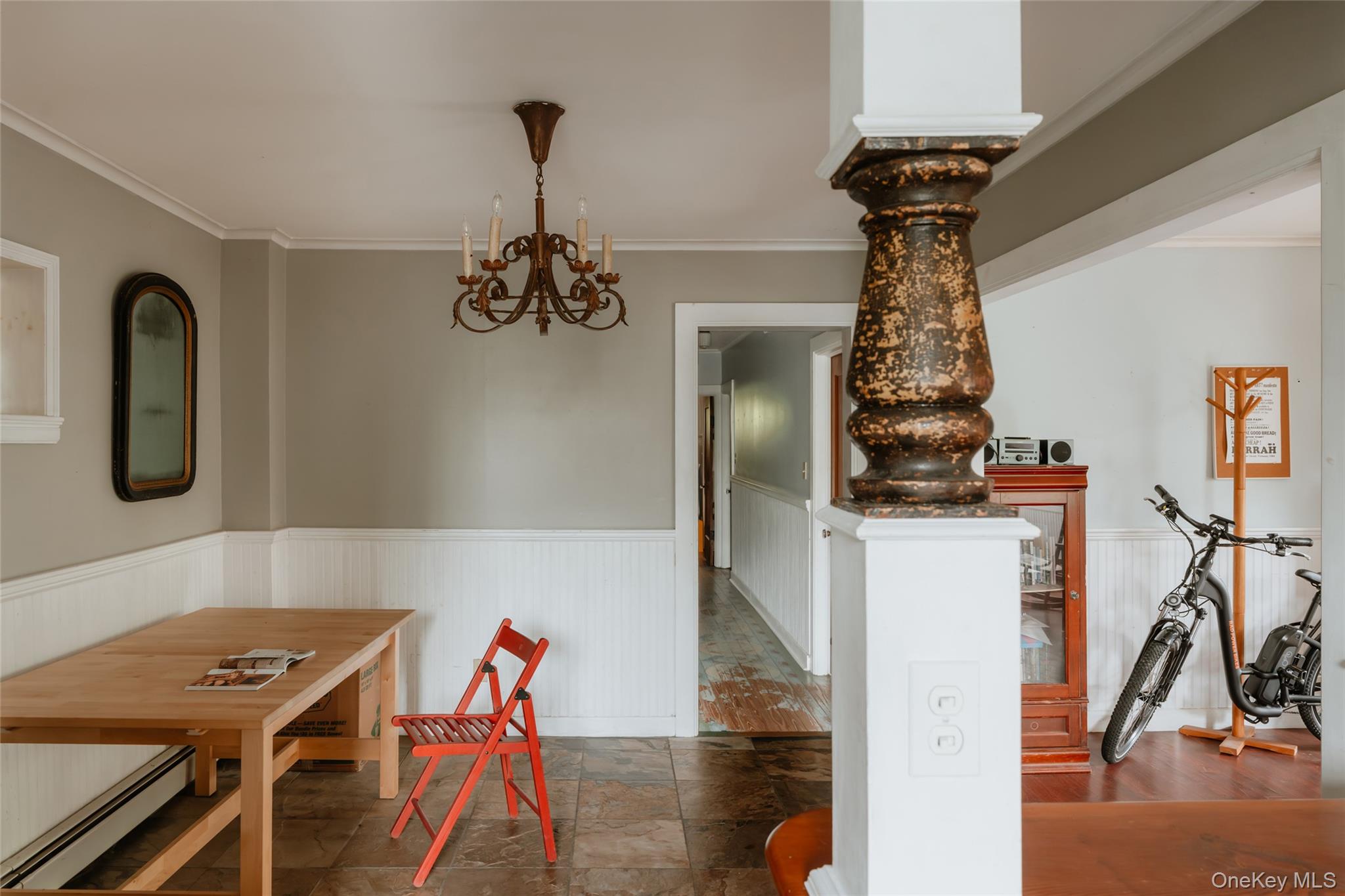 48 Upper Main Street Callicoon, NY 12723 - Photo 37 of 48 Dining room with ornamental molding, a baseboard radiator, a chandelier, wainscoting, and stone finish floors