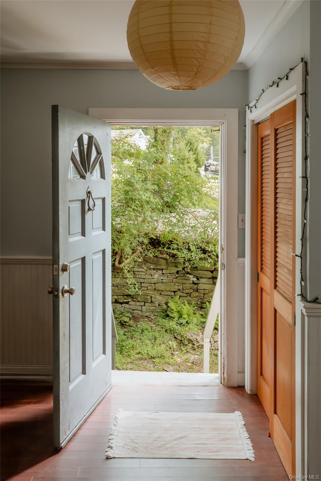 48 Upper Main Street Callicoon, NY 12723 - Photo 41 of 48 Doorway with wood finished floors, crown molding, and a wainscoted wall