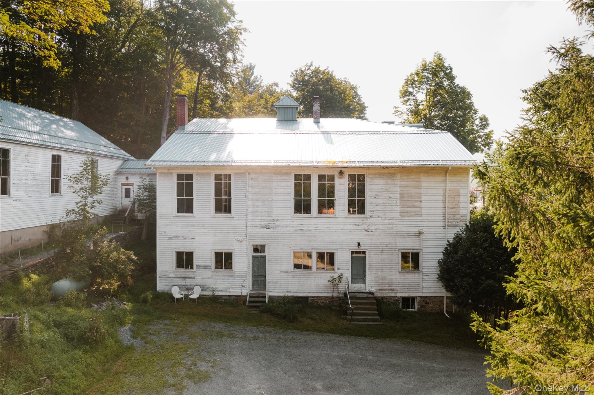 48 Upper Main Street Callicoon, NY 12723 - Photo 46 of 48 Rear view of house featuring entry steps, a metal roof, and a chimney