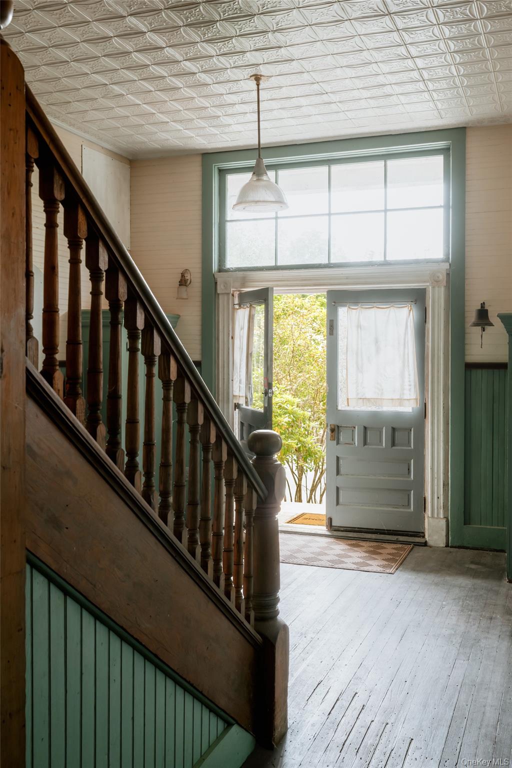 48 Upper Main Street Callicoon, NY 12723 - Photo 8 of 48 Entryway featuring stairs, an ornate ceiling, hardwood / wood-style floors, and wooden walls
