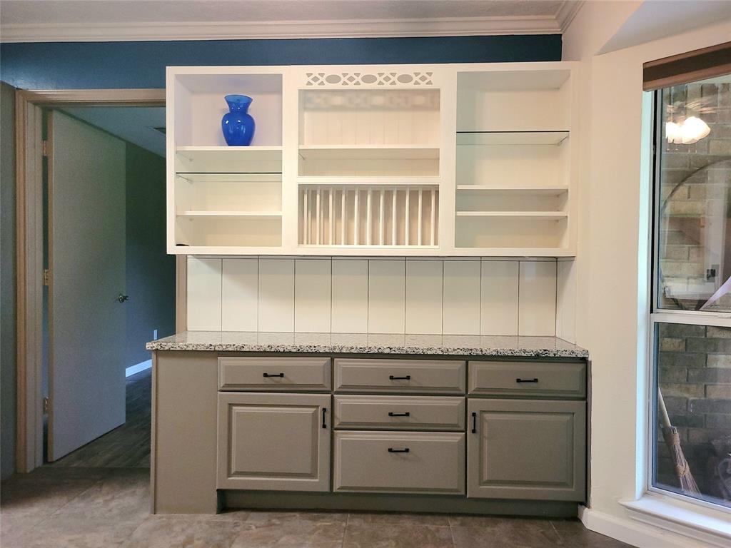 912 North Dove Road Grapevine, TX 76051 - Photo 11 of 36 a kitchen with granite countertop cabinets and a window
