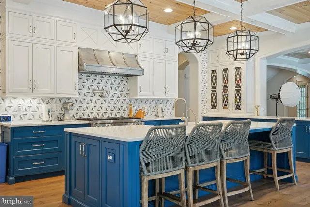 a large kitchen with stainless steel appliances granite countertop a sink and a counter top space