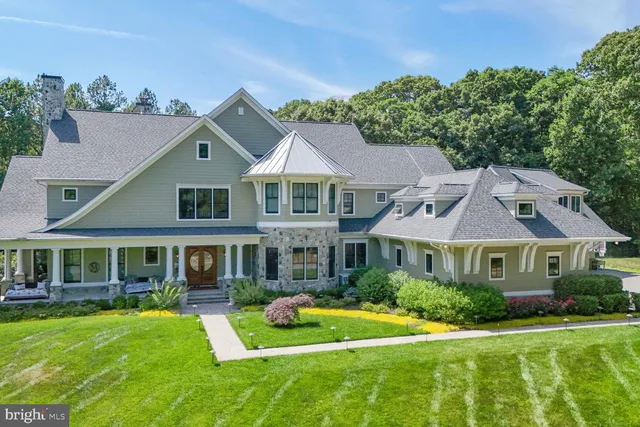 a living room with furniture a fireplace and a floor to ceiling window