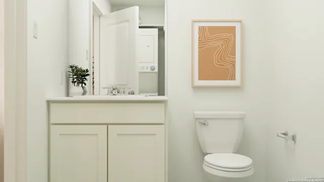 a bathroom with a sink a toilet and a mirror