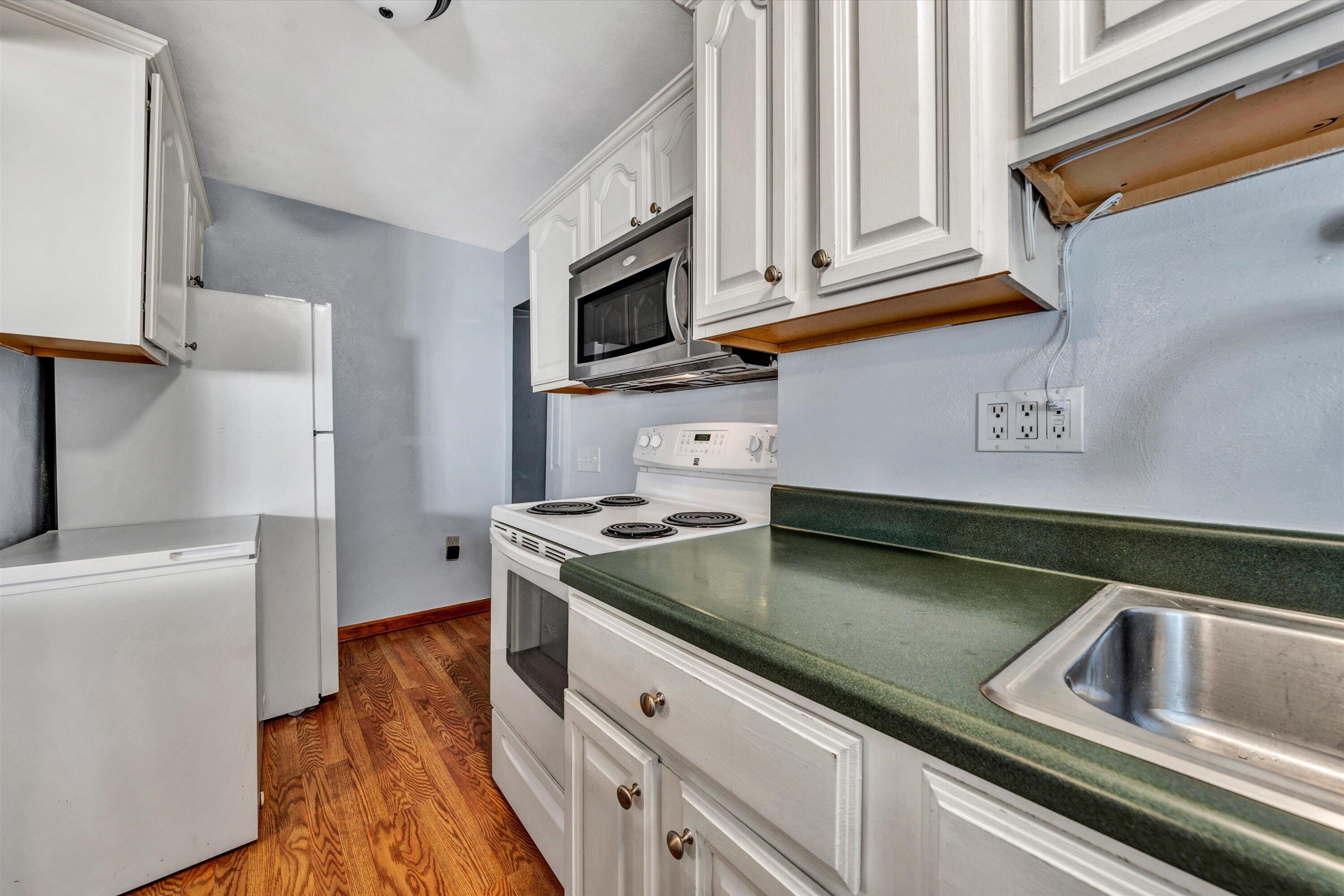 1120 Turner Branch Road Goodview, VA 24095 - Photo 12 of 35 a kitchen with stainless steel appliances granite countertop a sink and a stove