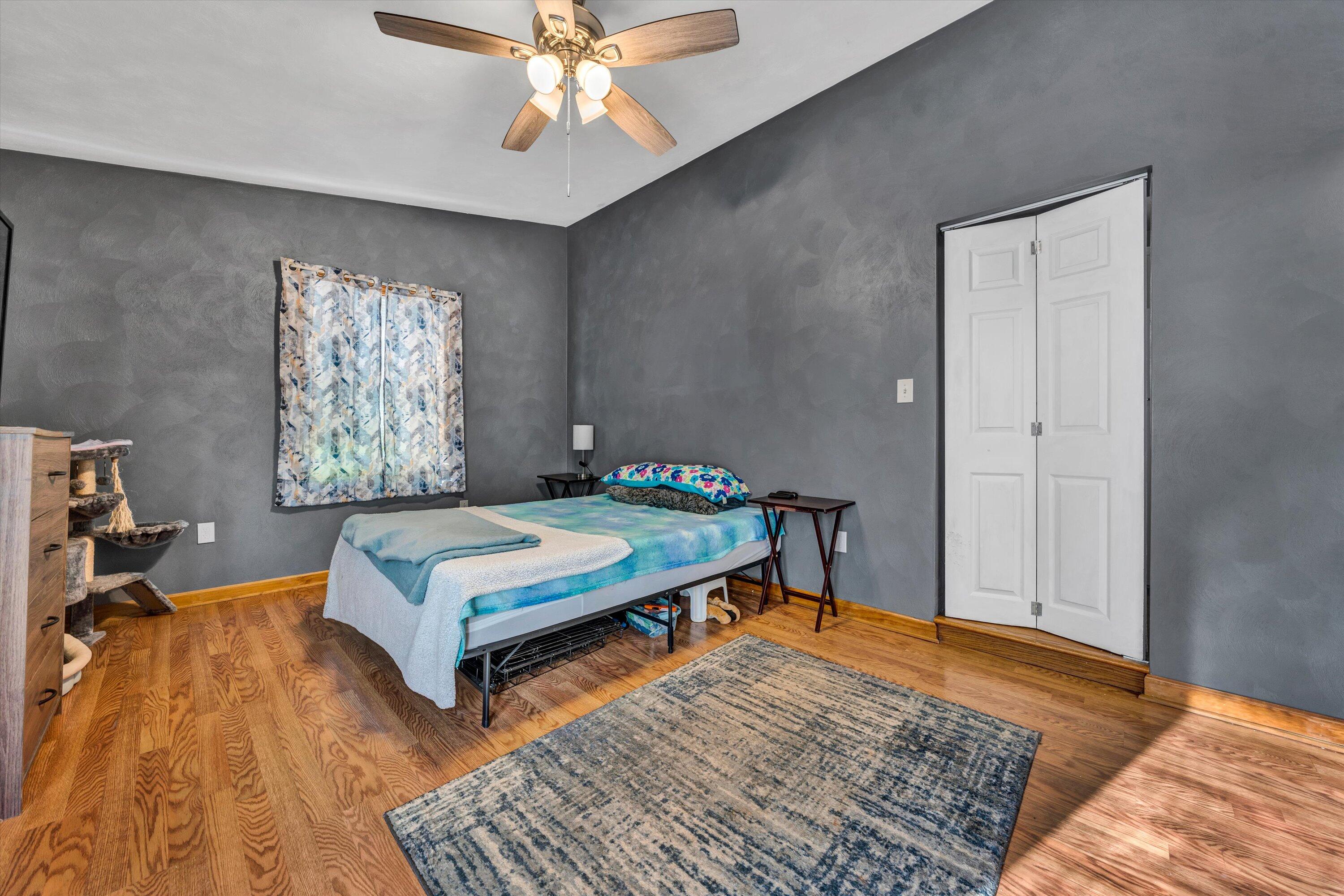 1120 Turner Branch Road Goodview, VA 24095 - Photo 23 of 35 a bedroom with a bed and wooden floor