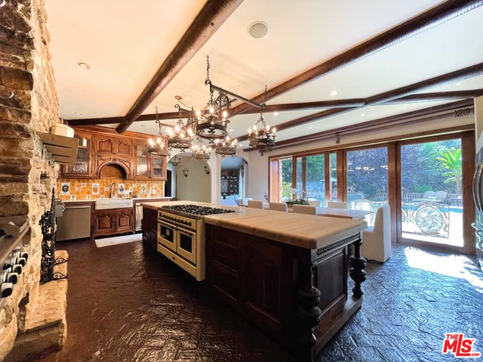 1016 Moraga Drive Los Angeles, CA 90049 - Photo 11 of 30 a living room with furniture and a large window