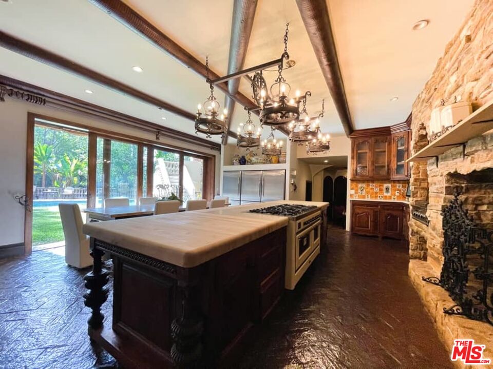 1016 Moraga Drive Los Angeles, CA 90049 - Photo 12 of 30 a kitchen with a stove and a large window