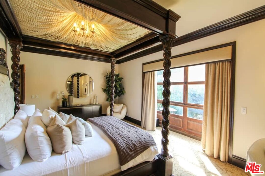 1016 Moraga Drive Los Angeles, CA 90049 - Photo 16 of 30 a bed room with furniture and a rug