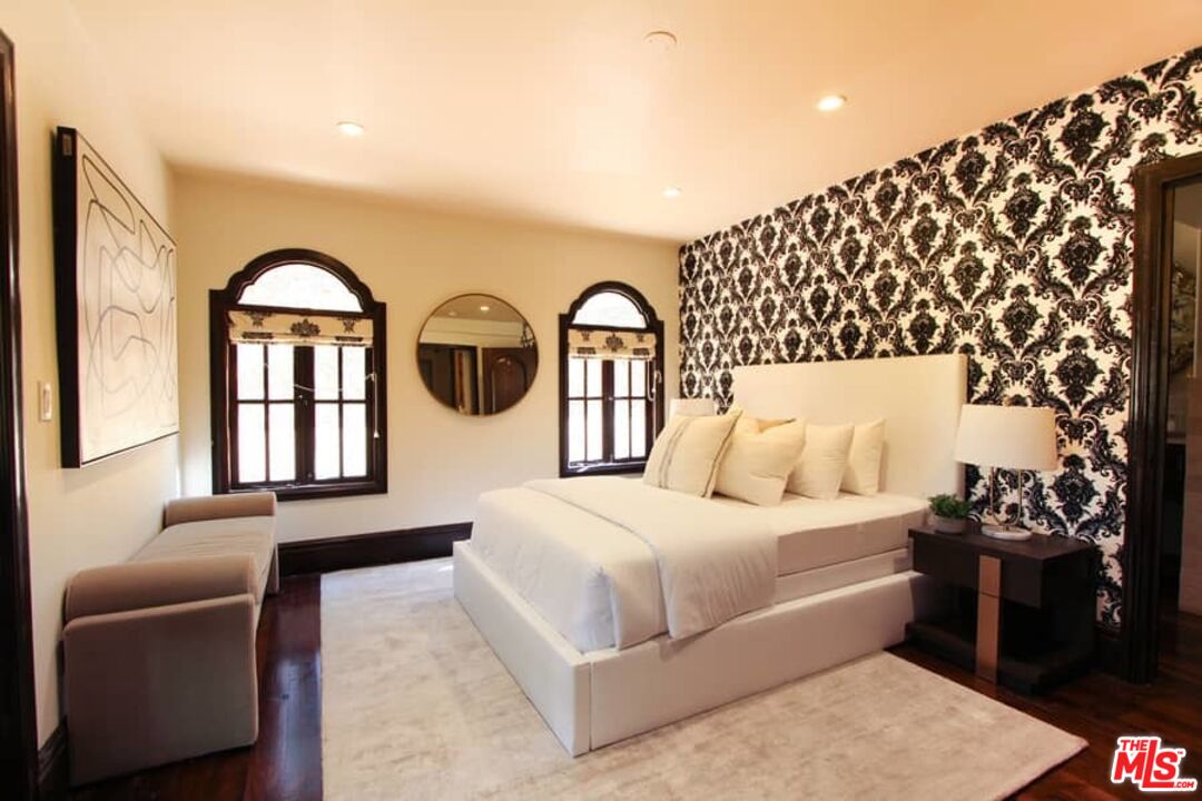 1016 Moraga Drive Los Angeles, CA 90049 - Photo 22 of 30 a bedroom with a bed and a large window