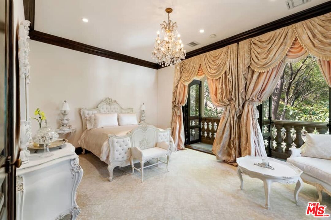 1016 Moraga Drive Los Angeles, CA 90049 - Photo 23 of 30 a bedroom with a bed and a large window