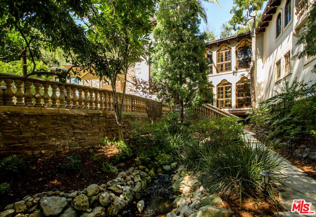 1016 Moraga Drive Los Angeles, CA 90049 - Photo 28 of 30 a view of a house with a tree